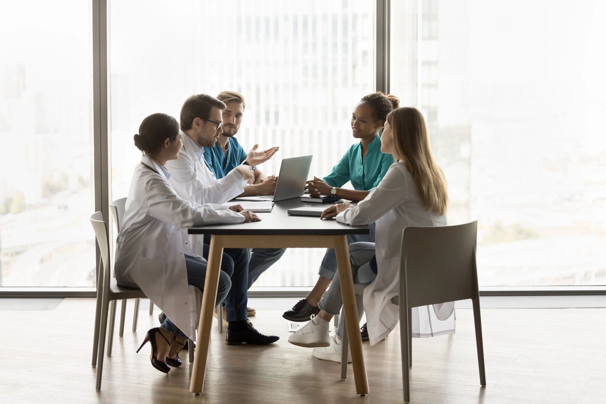 Medical professionals meeting around a table in a healthcare office